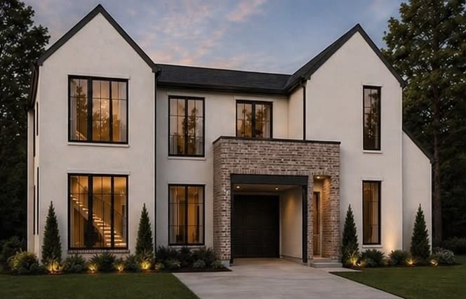 Front elevation of a two-story stucco custom residence at dusk with brick entry surround, Dallas, Texas